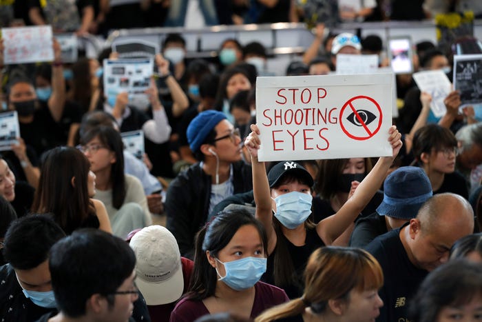 Teenage boy shot after Hong Kong imposes a ban on protesters wearing mask